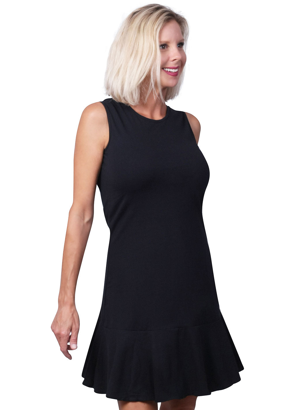 Woman wearing a black sleeveless dress with a round neckline and flounce hem