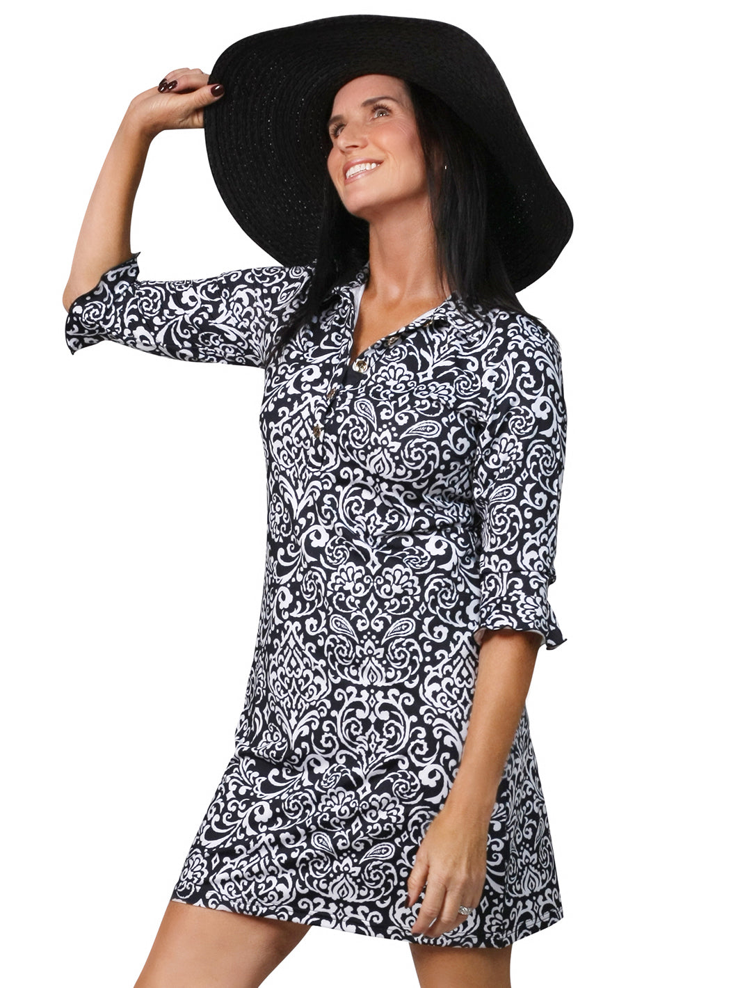 "Woman in black and white paisley print 3/4 sleeve golf top with wide-brim hat