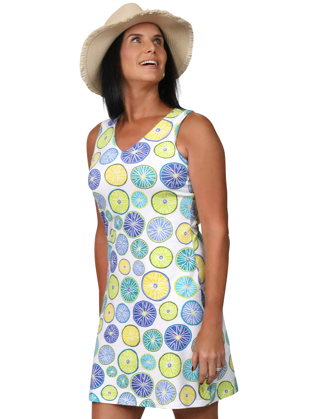 Woman wearing a sleeveless V-neck active dress in a blue, yellow and green citrus print with a straw sun hat